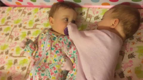 Twin Baby Girl Is The Cutest Pacifier Thief