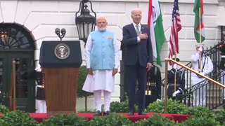 Biden, alongside Indian Prime Minister Narendra Modi, slowly lowers his hand from his heart after