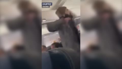 WATCH: Brave Passengers Stop Man Trying to Open Plane Door