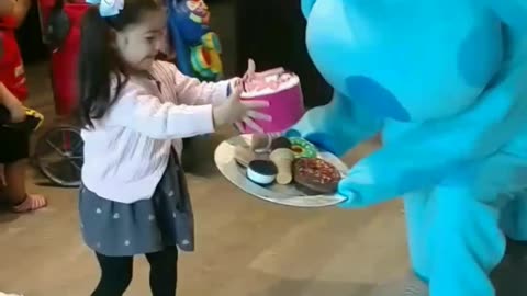 See this Blue dog play the birthday party treats at the birthday celebration