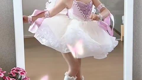 Girl dancing in front of mirror in princess costume