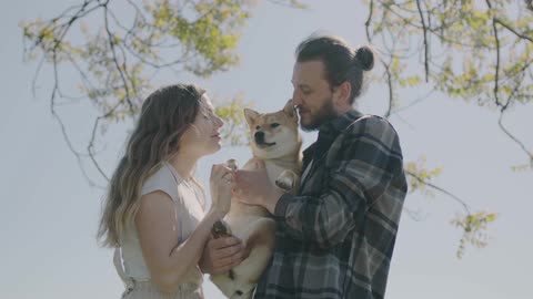 Loving couple kiss to dog