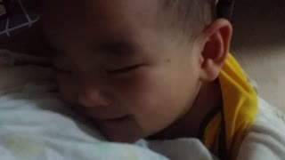 Sleeping baby has precious reaction to dad's "I love you"