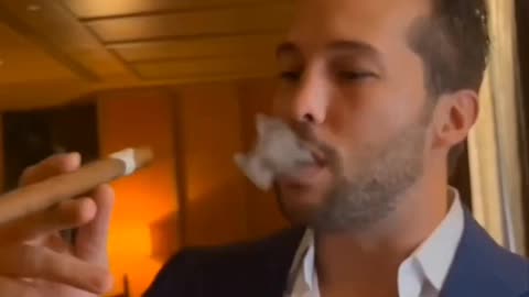 Tristan Tate smokes a £1300 cigar