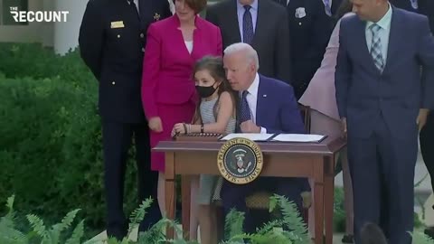 Pedo Joe creeping out little girl whispering in her ear as he leans on her
