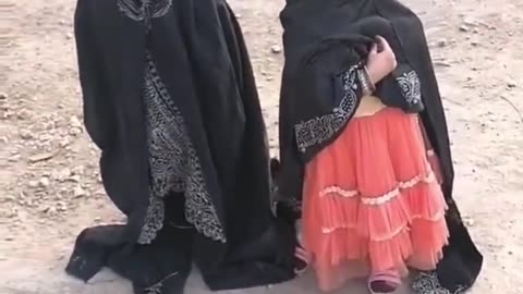 Two little muslim girls cover their heads with the Hijab when they hear that a man is coming