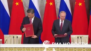 Putin and Xi Jinping sign documents on Russia-China strategic cooperation.