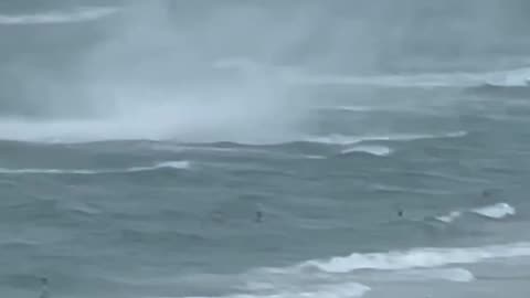 Footage capture waterspout ripping through crowd beach