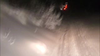 Snowmobiling through snowmaking mounds