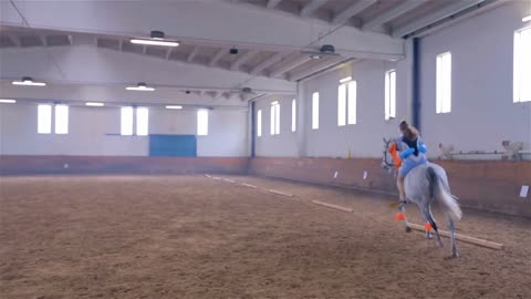 Swimsuit Girl Galloping Horse in Hall. Horse Riding Masquerade Competition in Big Riding Hall