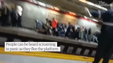 People run for cover as Iranian police open fire during protest at Tehran metro station