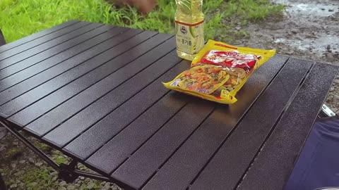 A bottle of rice wine and a piece of pickle cake are delicious during a one-man outdoor picnic on a