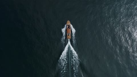 Drone Footage of a Motorboat Leaving a Water Trail