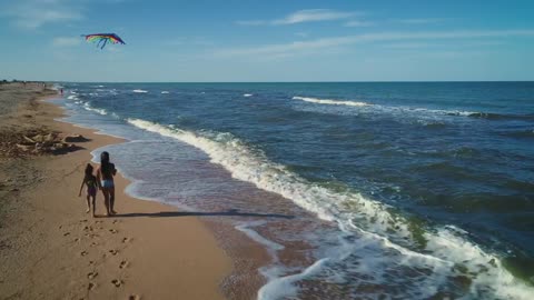 Girls flying a kite on the beach