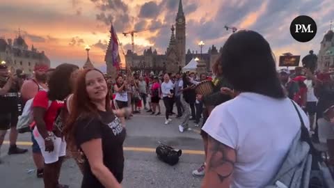 Canada Day freedom rally attendees in Ottawa dance at sunset