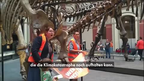 Climate activists glue themselves to dinosaur skeleton in Berlin