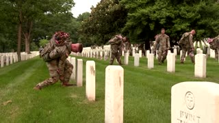 Soldiers place flags at graves before Memorial Day