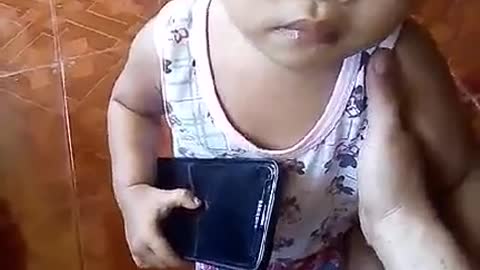 Little Filipina Girl is Startled while using phone