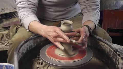 Making _ throwing a Pottery Candlestick on the wheel
