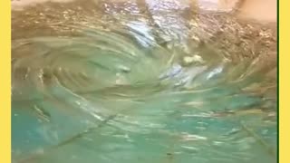 Water whirling round and round and round in a giant sink