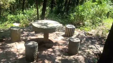 A table and stool made of stone.