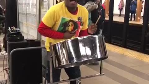 Man sings "could you be loved" bob marley at subway station, playing jamaican steel drum