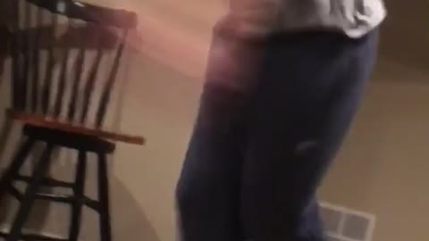 Guy in gray shirt dancing falls down
