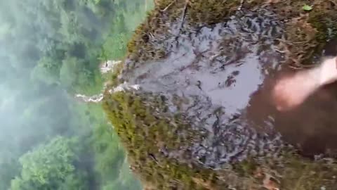 Couple film as they walk dangerously close to edge of 100-metre-high waterfall in Bosnia