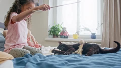 Baby girls playing with black cat. ll black cat love and. Cuteness ll