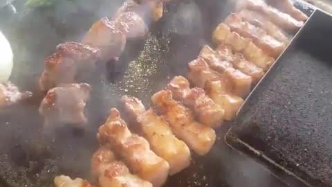 The sound of grilling pork belly