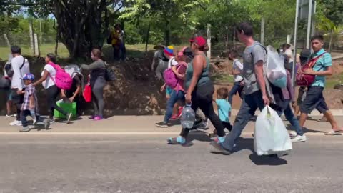 Hundreds of small children are walking or being carried in this caravan moving north through Mexico