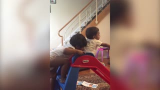 Older Sister Pushes Brother Down the Slide