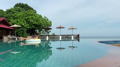 Infinity Relax of Woman in pool during Vacations