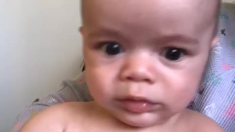 Shirtless baby cries and then makes faces at camera