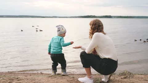 mom and son by the beach shore