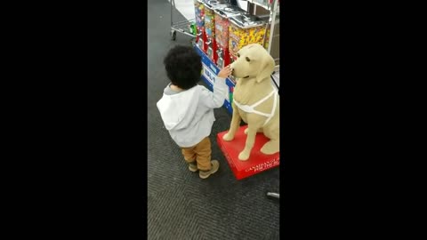 Toddler confuses dog statue for actual dog