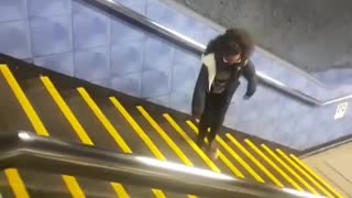 Girl glasses dancing up sideways yellow stairs train station