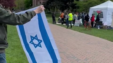 TPUSA chapter student at the U of Washington waves Israeli Flag at Hams Supporters