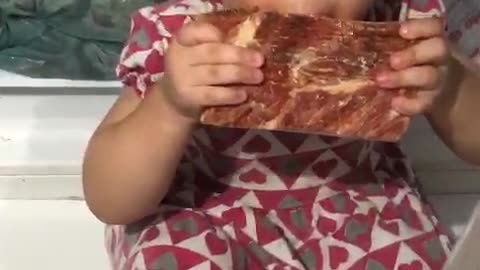 Girl Sneakily Enjoys Meat From the Freezer