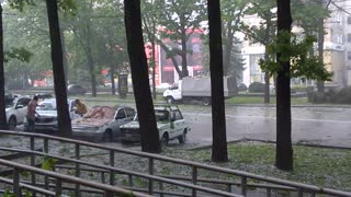 Lady Protects Car From Hail With Her Body