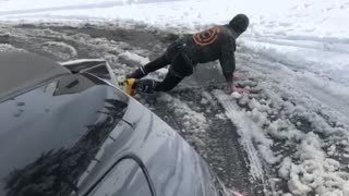 Guy skiing gets pulled by car, does the splits and falls down