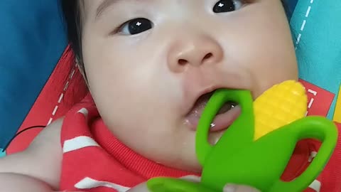 a baby eating corn chipper