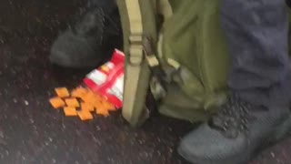 Man sleeps cheezits on floor in front of him