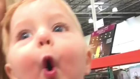 Little Boy Is Amazed by the Store's Christmas Decorations