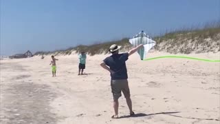 Guy releases kite into air, instantly flies back to hit him