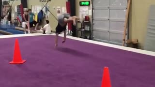Man grey shorts gymnastics trick face plant