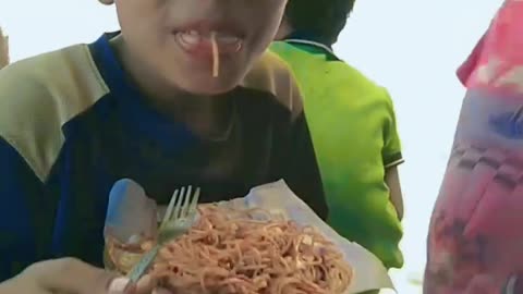 Little kids eating noodles