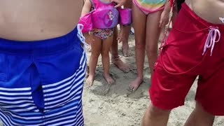 Baby Nurse Shark Latched onto Mans Arm at Beach
