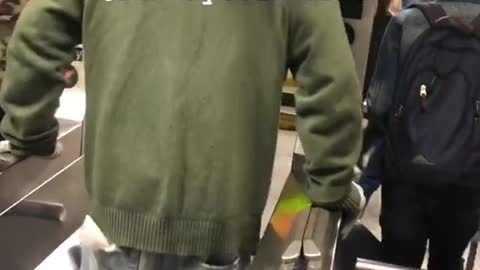 Guy green jacket doing push ups between turnstile