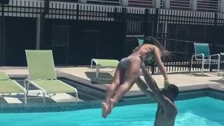 Man throws woman into pool bellyflop